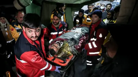 Anadolu Agency Survivor Hakan Yasinoglu being taken to ambulance