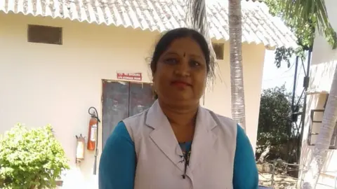 Shanti Teresa lakra Shanti Teresa lakra standing in front of a building