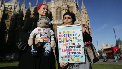 Getty Images Two women protesting against proposed pension changes