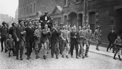 Topical Press Agency Scottish athlete and missionary, Eric Henry Liddell (1902 -1945) being carried round the streets after his Olympic victory
