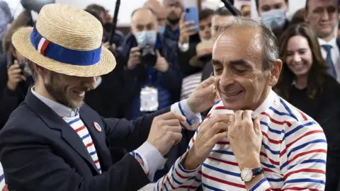 EPA French far-right polemicist Eric Zemmour tries on a striped shirt as he visits the "Made In France" expo at the Porte de Versailles exhibition hall in Paris, France, 14 November 2021