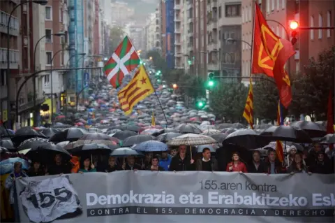 Reuters A demonstration against Article 155 of the Spanish Constitution allowing the Spanish Government to take control of Catalan institutions, in Bilbao, 4 November 2017. The banner reads "Democracy and the right to decide".