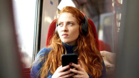 Woman looking concerned on train