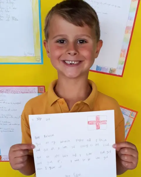 St John the Evangelist Primary School Sam with his letter to England footballer Raheem Sterling