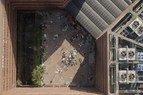 Getty Images An aerial view shows the main entrance (top R) to the campus and debris leftover from protesters who barricaded themselves inside, at the Hong Kong Polytechnic University in the Hung Hom district in Hong Kong on 22 November 2019.