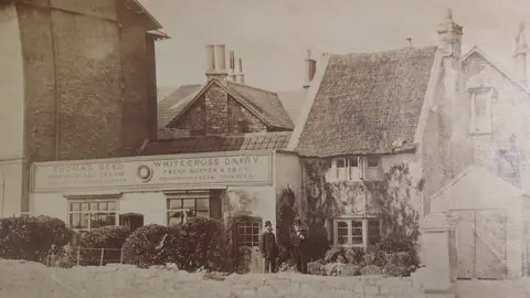 The Old Thatched Cottage restaurant A black and white picture of the building in the 1800s when it was a dairy