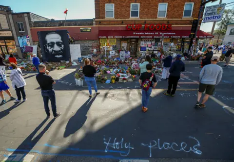 Reuters Visitors look at a memorial at the site of the arrest of George Floyd, who died while in police custody, in Minneapolis, Minnesota, US