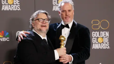 Reuters Guillermo del Toro and Mark Gustafson with the award for best animated picture for Pinocchio