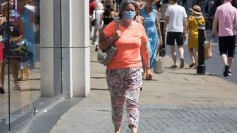 Getty Images Woman wears a face covering in Windsor