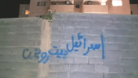 Supplied "Israel hit the Supreme leader's house" graffiti in Iran