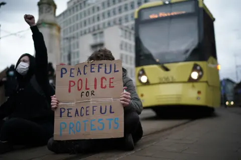 Christopher Furlong / Getty Images Demonstrators block the tram tracks during a Kill the Bill protest in Manchester, on 27 March 2021