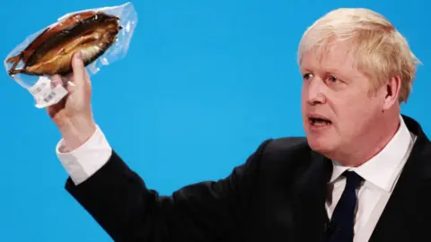Getty Images Picture of Boris Johnson holding a kipper at the Conservative leadership hustings
