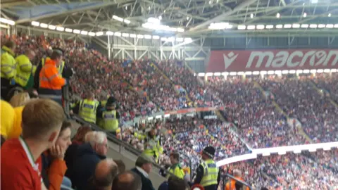 BBC Spectators and police inside the stadium