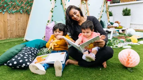 Tiney Children and a worker at a Tiney home nursery