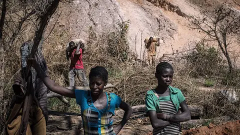 Getty Images Women waiting near a mine in DRC