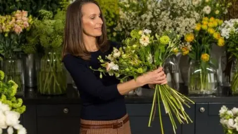 PA Philippa Craddock holding flowers