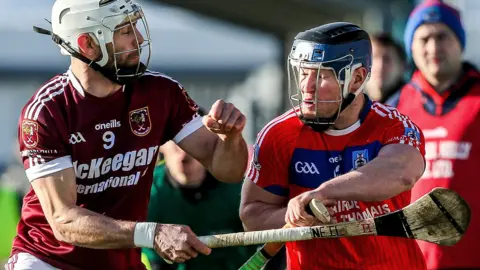 Cushendall's Neil McManus battles with St Thomas' Bernard Burke