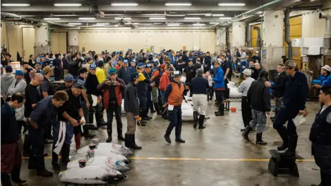 AFP Buyers, workers and auctioneers attend the final tuna auction at the landmark Tsukiji fish market in Tokyo on October 6, 2018