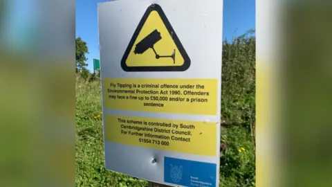 Janine Machin/BBC Council notice warning of penalties for fly-tipping