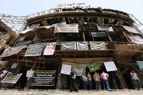 AFP Relatives of victims of the Karrada bombing gather at the site on 5 July 2016