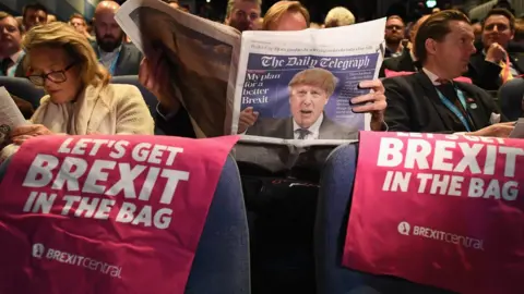 AFP A delegate reads The Daily Telegraph as they attend the annual Conservative Party Conference on 30 September 2018 in Birmingham