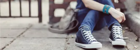 Getty Images Anxious girl sat on floor