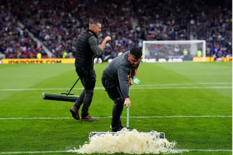 PA Media Clearing Hampden pitch of water