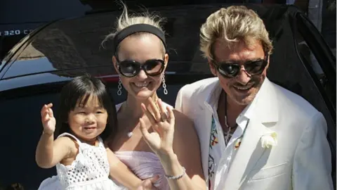 AFP/Getty Images This file photo taken on July 29, 2006 shows French singer and actor Johnny Hallyday, his wife Laeticia and their daughter Jade