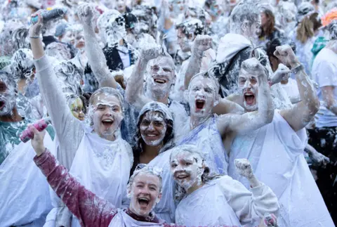 Lesley Martin / PA Media Students pose after taking part in a foam fight