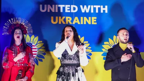 Reuters Singer Jamala and the Antytila band sing the Ukrainian national anthem during a vigil for Ukraine held on the anniversary of the conflict with Russia, at Trafalgar Square in London, Britain February 23, 2023