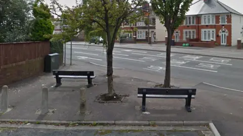 Google Two benches overlooking a busy road in Cardiff.