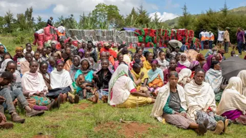 AFP A group of Internally Displaced People ( IDP ) waits for aid distribution near their shelters on May 20, 2019 at Qercha village, Southern Ethiopia