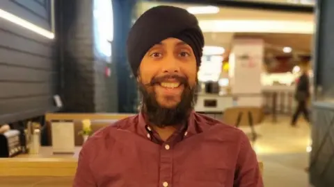 Gurvinder Singh Gurvinder smiling at work