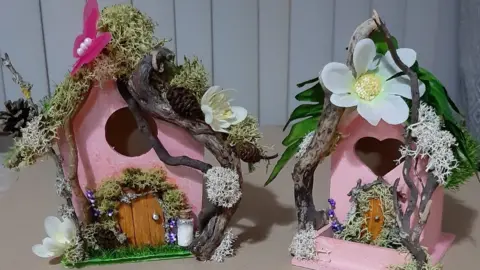 Pink bird houses with elf doors