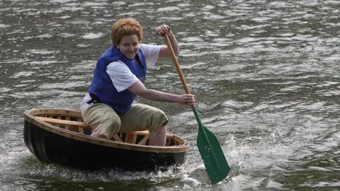 Getty Images Woman in a coracle on River Severn