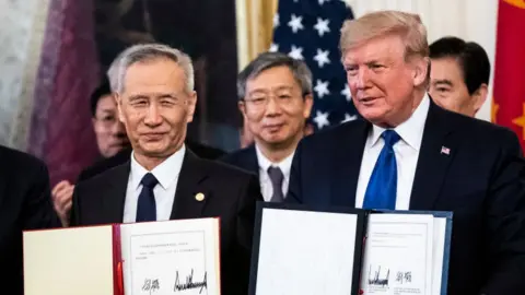 Getty Images President Donald J. Trump signs a trade agreement with Chinese Vice Premier of the People's Republic of China, Liu He in the East Room at the White House on Wednesday, Jan 15, 2020 in Washington, DC.