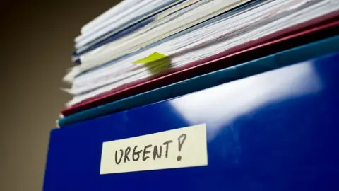 Getty Images Pile of papers in an in-tray