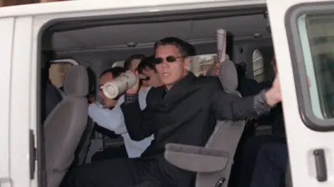 PA Jamie Acourt, one of the five named suspects of killing black teenager Stephen Lawrence, leave after giving evidence