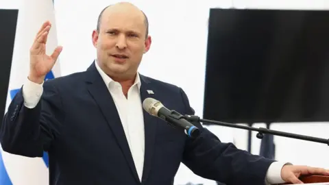 Reuters Naftali Bennett speaks at the Jewish settlement of Beit El, in the occupied West Bank (5 April 2022)