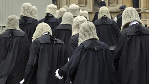 Getty Images British judges wearing traditional ceremonial wigs and robes in a procession at Westminster, London