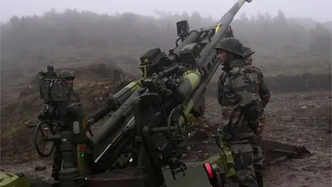 Getty Images Indian Army soldiers stand next to a M777 Ultra Lightweight Howitzer positioned at Penga Teng Tso ahead of Tawang, near the Line of Actual Control (LAC),