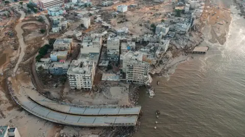 Waleed al-Talib Drone shot shows destruction in Derna including a large road which has been swept away