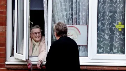 Tony Fisher Two women talking at a window