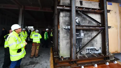 Wales News Service Contractors inspect the Banksy