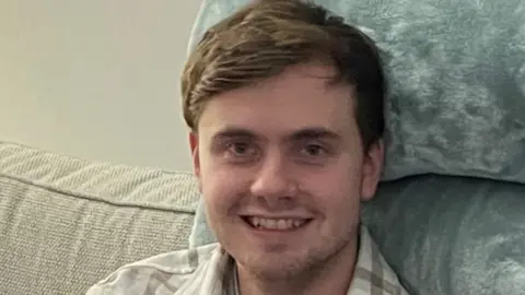 Family photo Jack O'Sullivan sitting down smiling at the camera