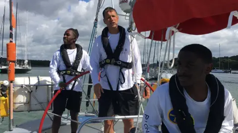 BBC Jon Holt centre, with members of Greig City Academy's Fastnet team