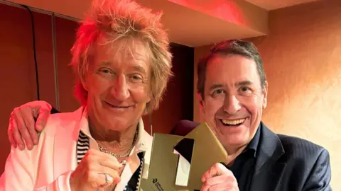 Official Charts Company Sir Rod Stewart and Jools Holland holding their number one chart trophy