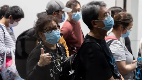 EPA Passengers disembark from the World Dream cruise liner