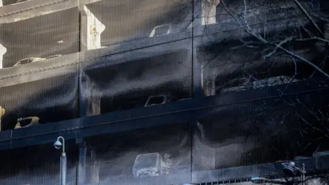 Peter Byrne/PA Burned out cars