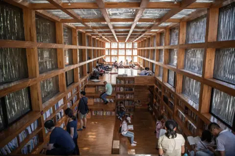 FRED DUFOUR/AFP/Getty Images People reading inside Liyuan Library